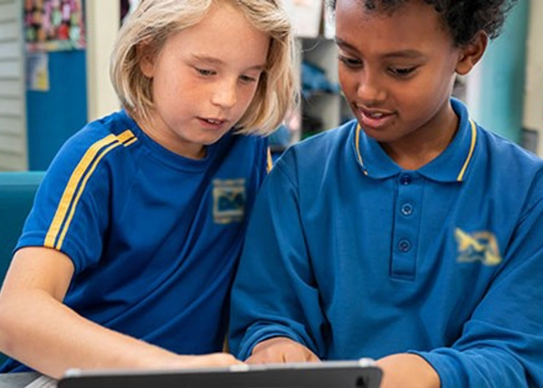 Two children using a tablet device